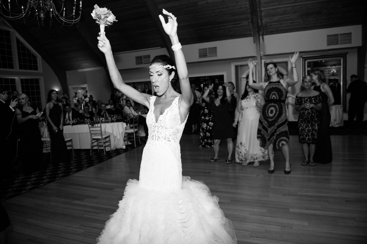 long beach island wedding lbi bonnet island estate jersey shore merrimaker caterers happy bride and groom candid happy dancing reception funny candid bouquet toss black and white