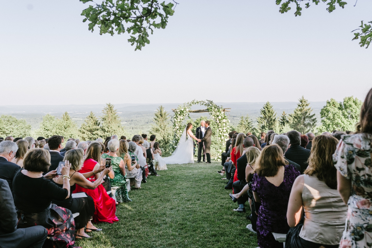 Cedar Lakes Estate Summer Wedding Port Jervis NY Camp Inspired Wood Forest Trees Greenery Just married Golf Cart happy love golden light bright lake details faye and renee flowers florals rustic barn candid groom ceremony happy sunlight bride and groom ceremony archway faye and renee mountaintop