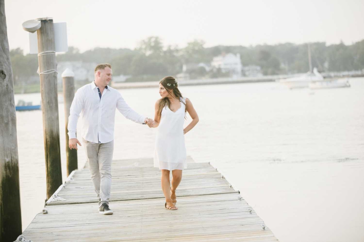 Walking Happy Couple Dock Sunset golden hour magic hour Happy Candid Smiling Red Bank NJ Summer Engagement Session Water Row boat Water Ocean Bay Jersey Shore
