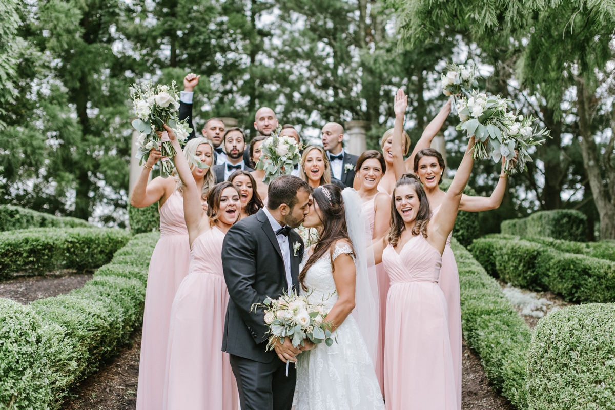 bridal party cheering bride and groom kiss blush tones ashford estate timeless wedding classic nj new jersey allentown love 