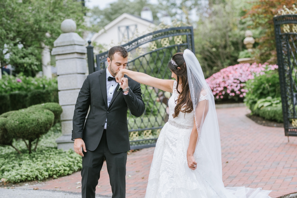 groom kisses brides hand sweet moment candid bridal party silly fun ashford estate timeless wedding classic nj new jersey allentown love 