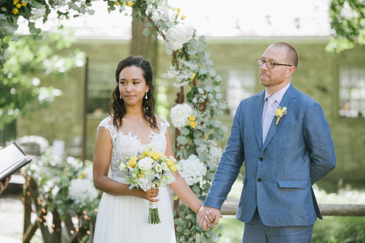 Sunny day sunshine Flower trellis archway Inn at Millrace Pond New Jersey Rustic Intimate Summer Wedding Yellow Flowers Bouquet Happy Candids Bride and Groom ceremony