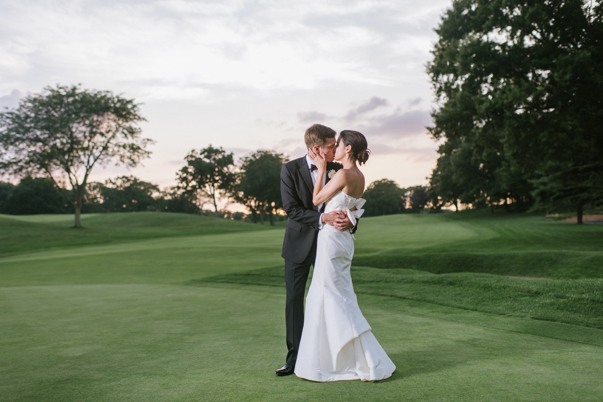 bride and groom golf course sun set kiss Manasquan River Golf Club Spring Lake NJ St. Catherine's Church Timeless Classic Wedding