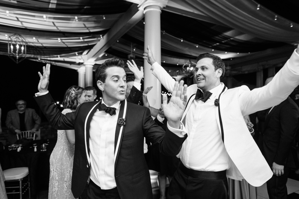 grooms dancing candid funny black and white candid reception The Chanler at Cliff Walk Newport Rhode Island New England Elegant Destination Wedding on the coast same sex couple lgbtq love is love gay couple love wins