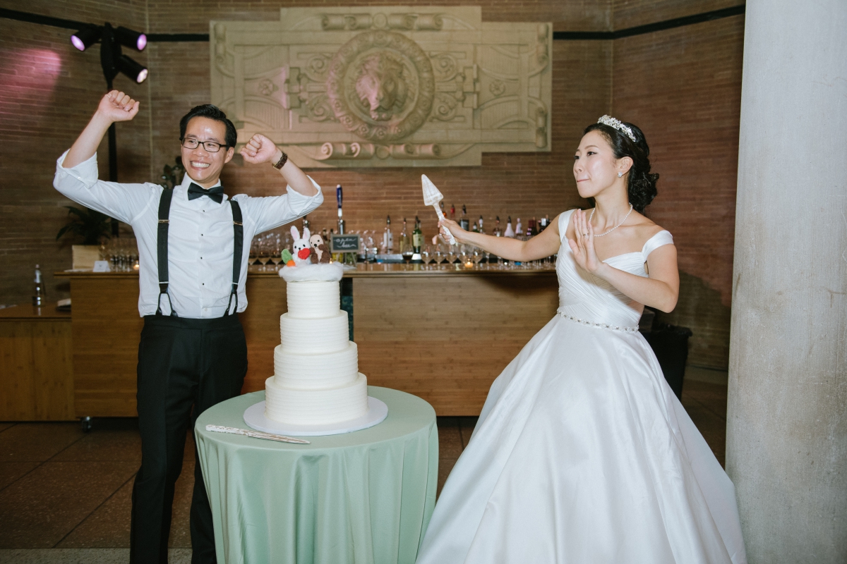 bride and groom fun candid cake cutting Bronx Zoo Wedding Animal Lovers Keystone Endangered Species Environmentalists No Waste Wedding