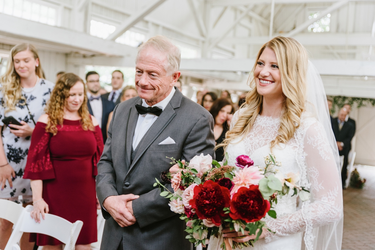 bride coming down the aisle with dad ceremony bouquet Ashford Estate Fall Wedding faye and renee florals flowers fountain elegant classic clean and modern estate mansion