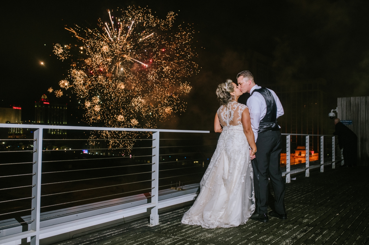 fireworks kissing night time bride and groom beach One Atlantic Wedding Atlantic City New Jersey