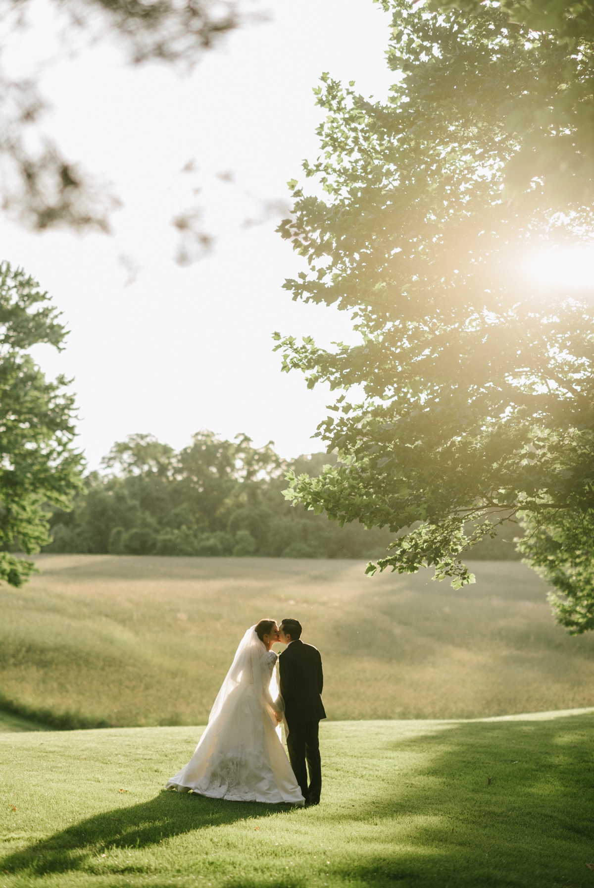 Bride and Groom Kissing Outdoors at Sunset at The Ashford Estate