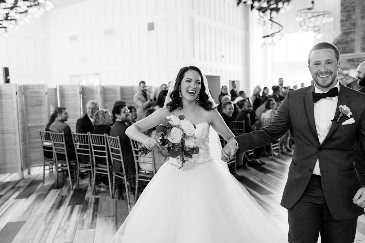 A Fun and Playful wedding at the Ryland Inn Coach House bride walking down aisle