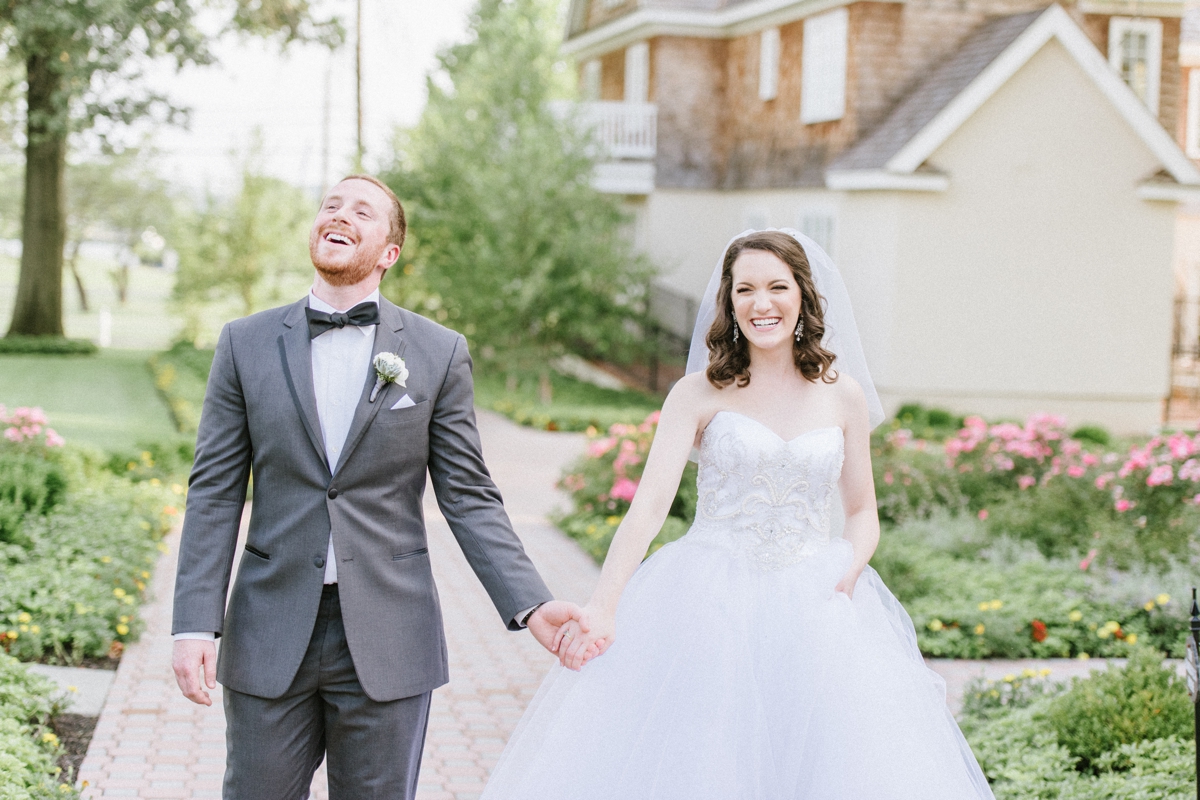 A Fun and Playful wedding at the Ryland Inn Coach House bride and groom walking outside
