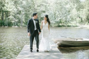 Cedar Lakes Estate Summer Wedding Port Jervis NY Camp Inspired Wood Forest Trees Greenery Just married Golf Cart happy love golden light bright kiss lake first look waterfront happy candid holding hands dock row boat