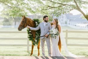 The Ryland Inn Whimsical Wedding July Summer Whitehouse Station NJ details ceremony site flowers florals archway antique vintage props outdoor ceremony antiques bride and groom horse sunlight sunset