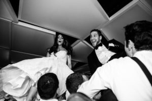 Black and White horah jewish traditions dancing reception happy candid laughing smiling husband and wife Hudson at Maritime Parc Jewish Wedding Jersey City