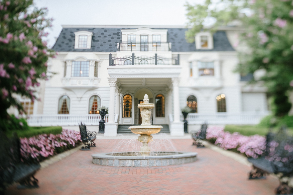 Weddings of Distinction Merrimaker Caterers Ashford Estate Summer Wedding by Gilded Lilly Events Fountain front of main building at Ashford Grand Elegant Classic Garden Theme