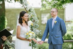 ceremony Sunny day sunshine Flower trellis archway Inn at Millrace Pond New Jersey Rustic Intimate Summer Wedding Yellow Flowers Bouquet Happy Candids Bride and Groom