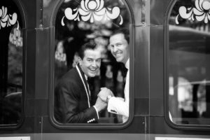 grooms black and white trolley happy candid fun The Chanler at Cliff Walk Newport Rhode Island New England Elegant Destination Wedding on the coast same sex couple lgbtq love is love gay couple love wins