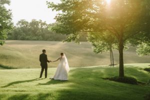 Bride and Groom at sunset in field at The Ashford Estate