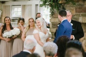 Bride laughing during ceremony at the Ashford estate