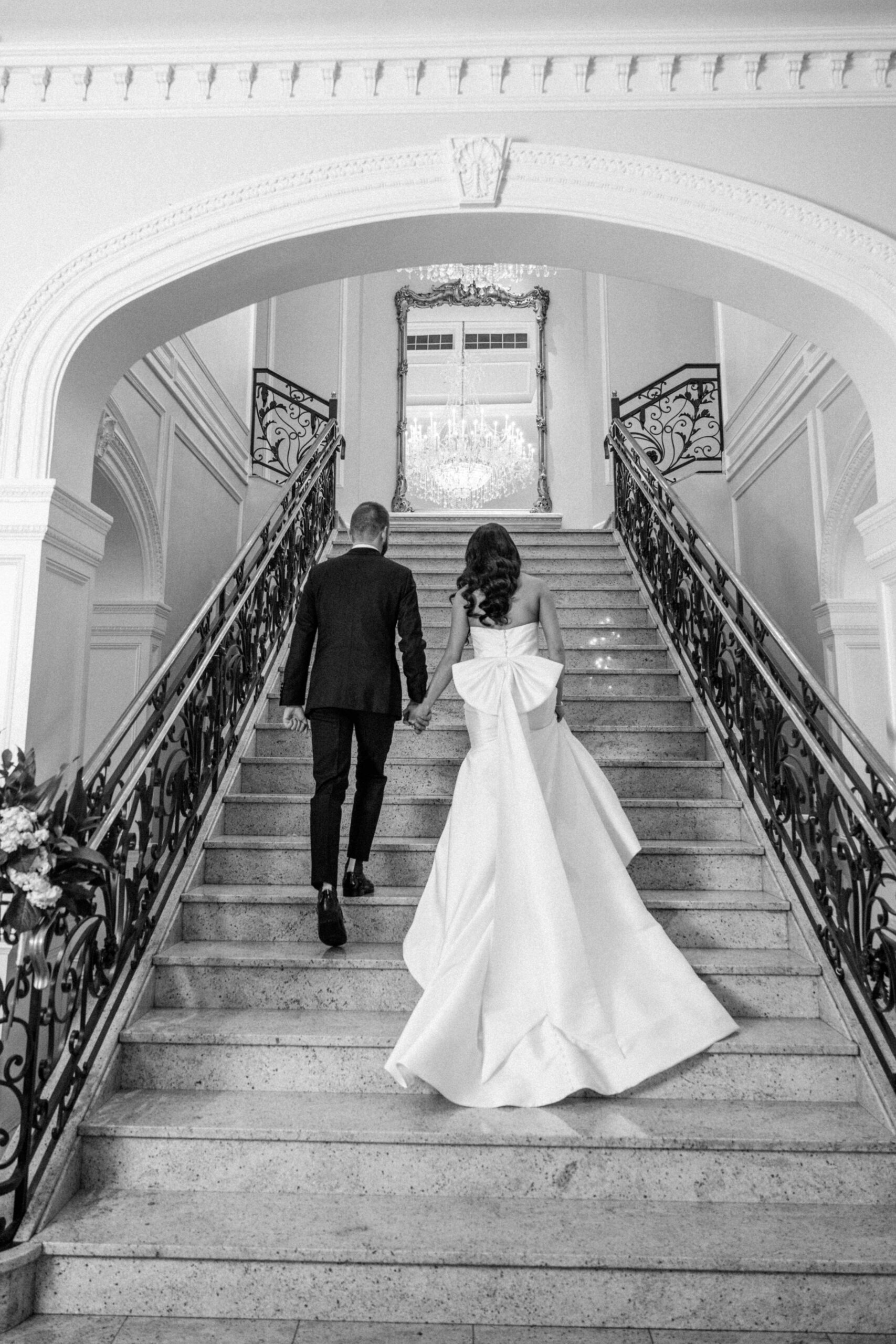 bride-and-groom-walk-up-stairs-at-the-rockleigh