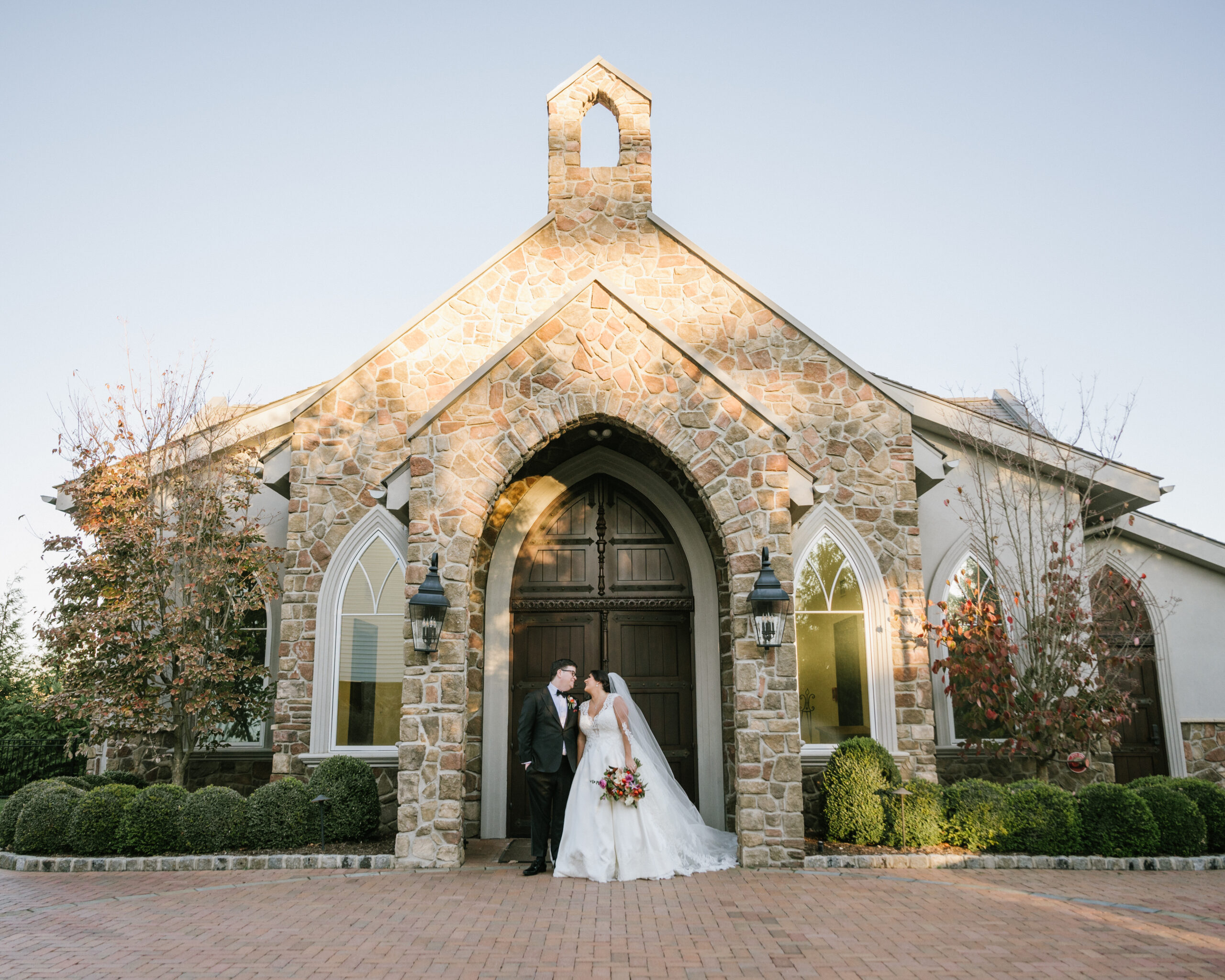 Married Couple celebrating outside the chapel at The Park Savoy all inclusive wedding venue in New Jersey