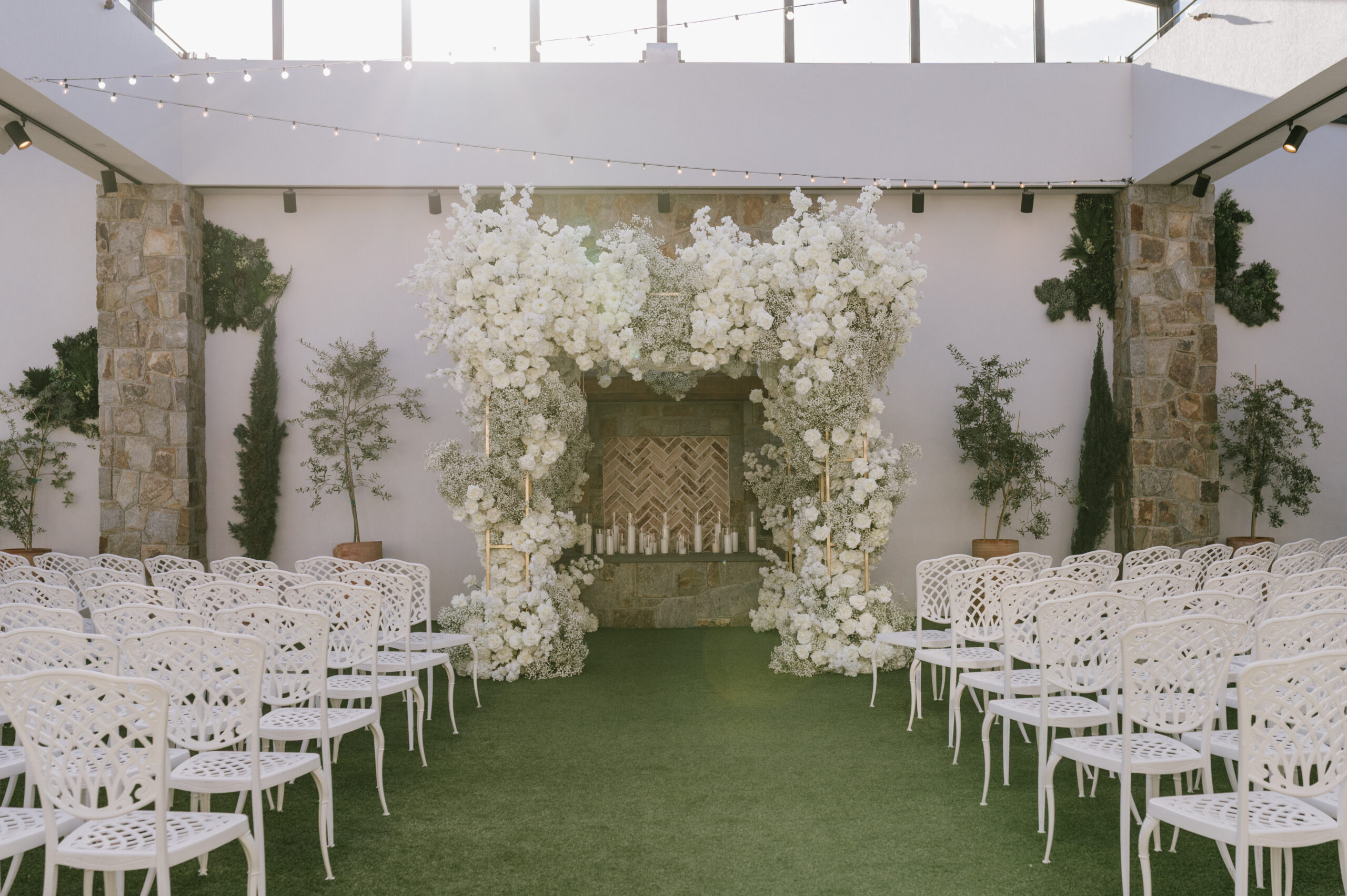 Winter wedding ceremony at The Reserve at Perona Farms with white floral chuppah and elegant white chairs in New Jersey.